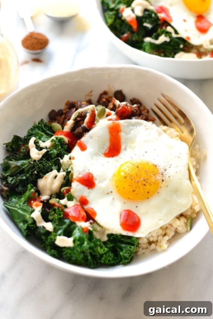 53 Game-Changing Plant-Based Recipes 9 Savory Black Bean Breakfast Bowl with kale, brown rice, and egg.