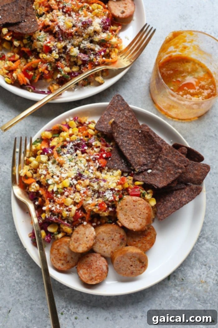 Serve Your Thai Chili Corn Salad with Grilled Meats and Sides Thai Chili Corn Salad in a serving bowl, presented beautifully as a vibrant side dish alongside perfectly grilled sausage and a bowl of crunchy tortilla chips on a rustic wooden table, ready for a summer meal.
