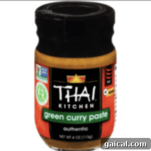 Sunshine Corn Salad 2 A jar of green curry paste, a key ingredient for Thai cuisine, shown clearly on a white background.