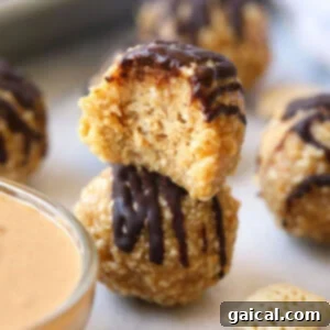 Crunchy no bake peanut butter balls stacked, showing a delicious texture.