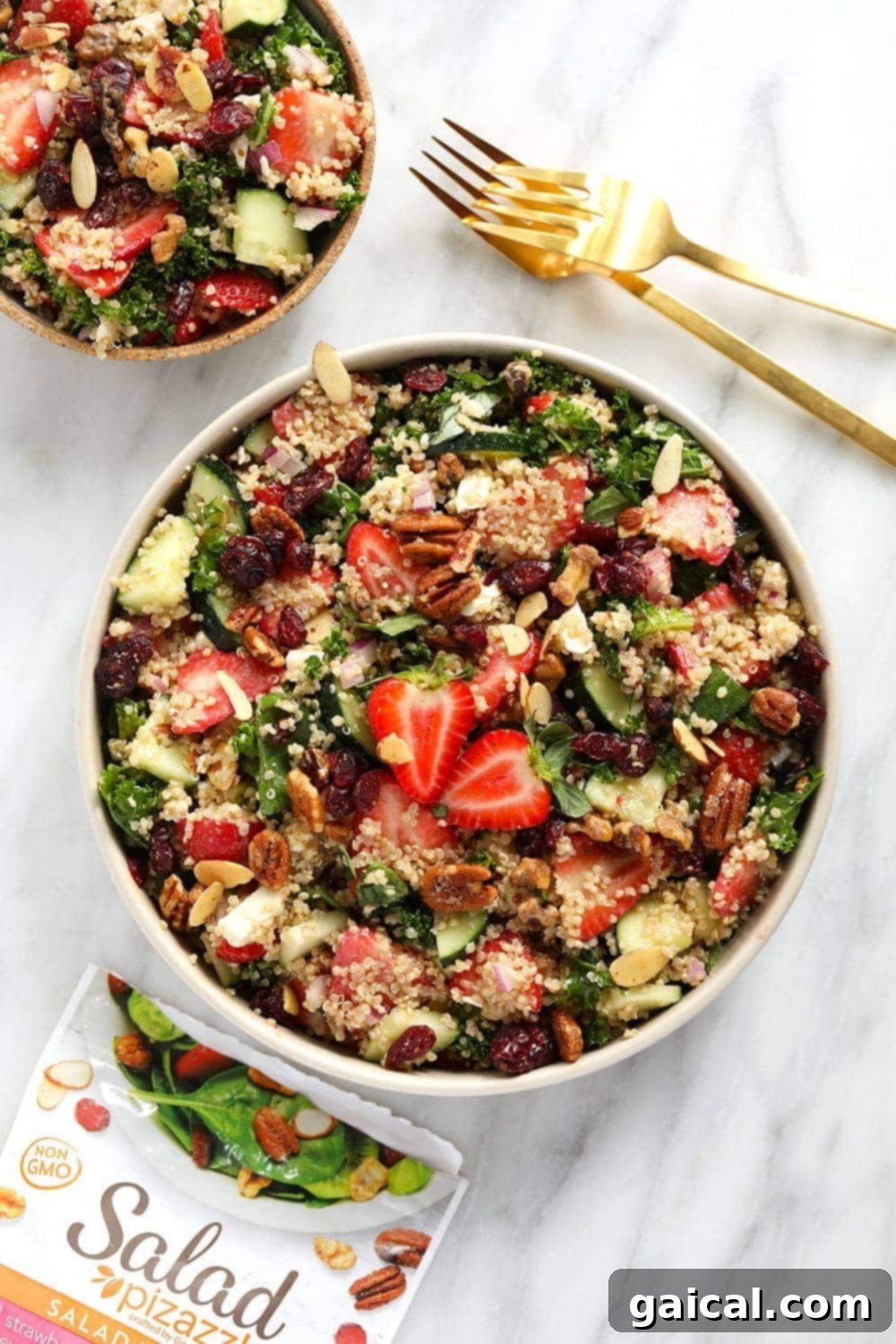 Delicious Strawberry Quinoa Salad with creamy balsamic dressing. A vibrant bowl of Strawberry Quinoa Salad with kale, strawberries, cucumber, and feta.