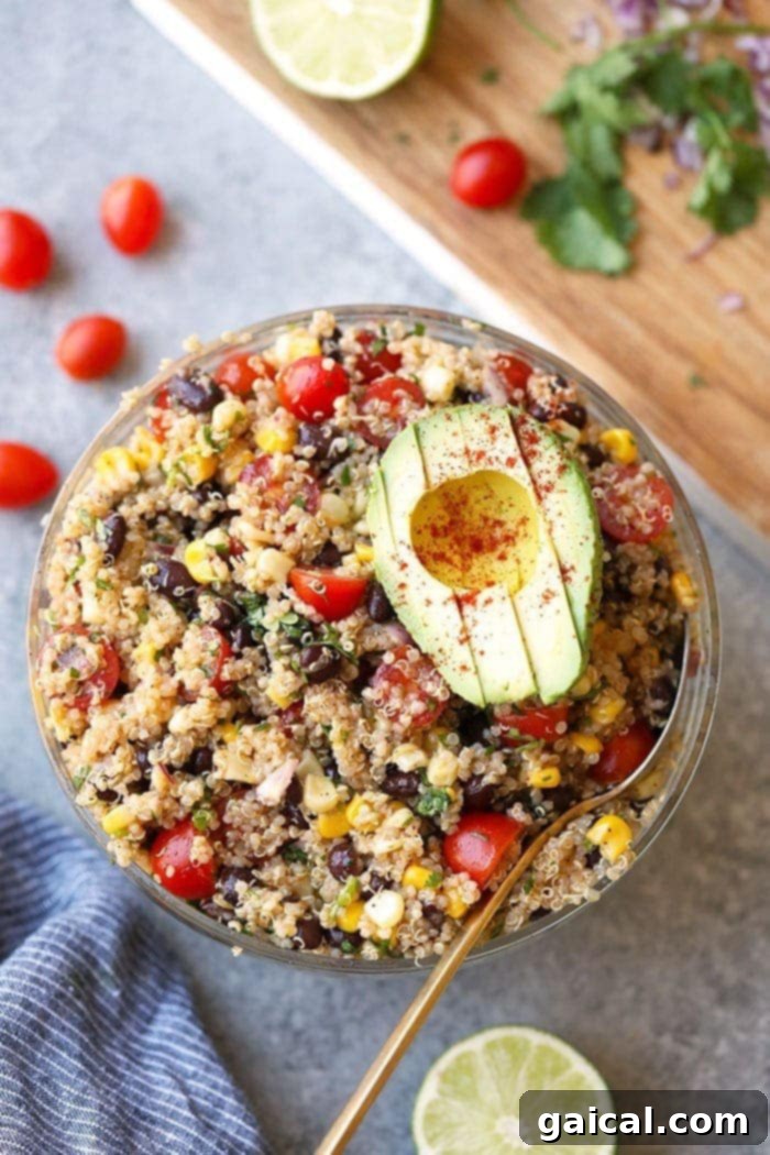Refreshing Mexican Quinoa Salad - Vegan & Gluten-Free. A colorful bowl of Mexican Quinoa Salad with corn, black beans, and avocado.