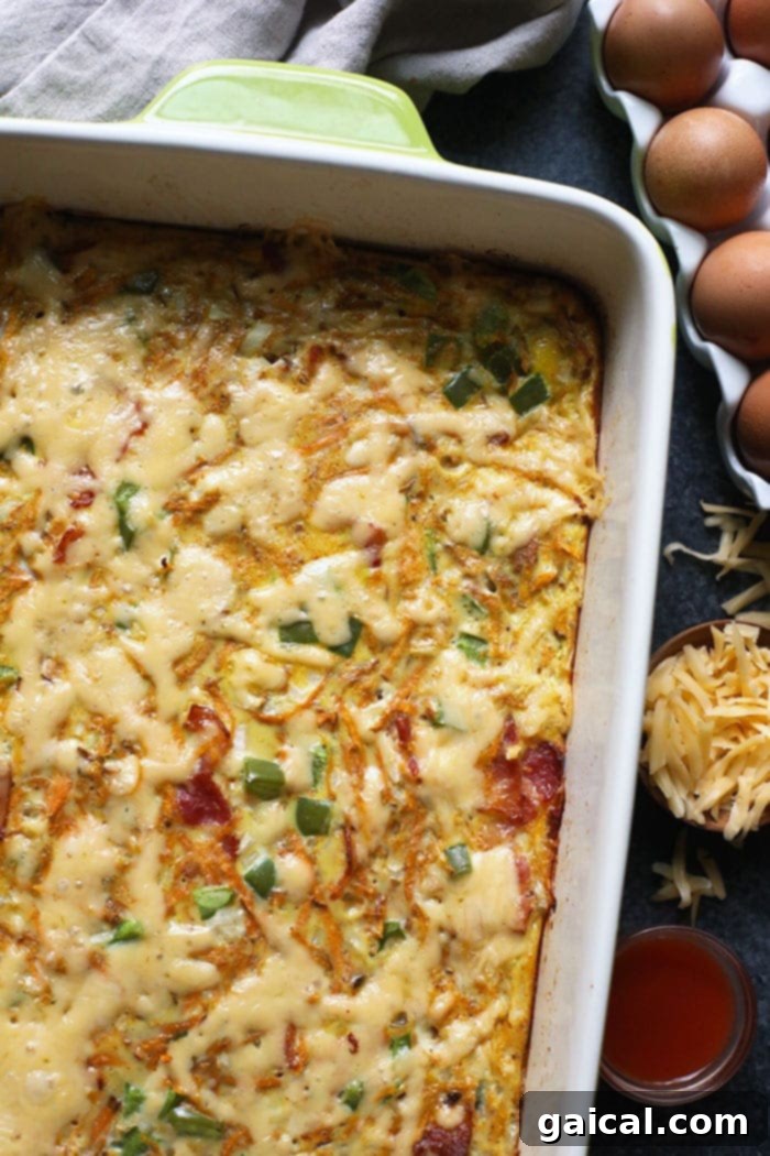 Finished Sweet Potato Hash Breakfast Casserole with Melted Cheese A baked sweet potato hash breakfast casserole, golden brown and topped with melted gouda cheese, ready to be served.