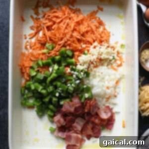 Healthy breakfast casserole with eggs, carrots, bacon, and other ingredients.