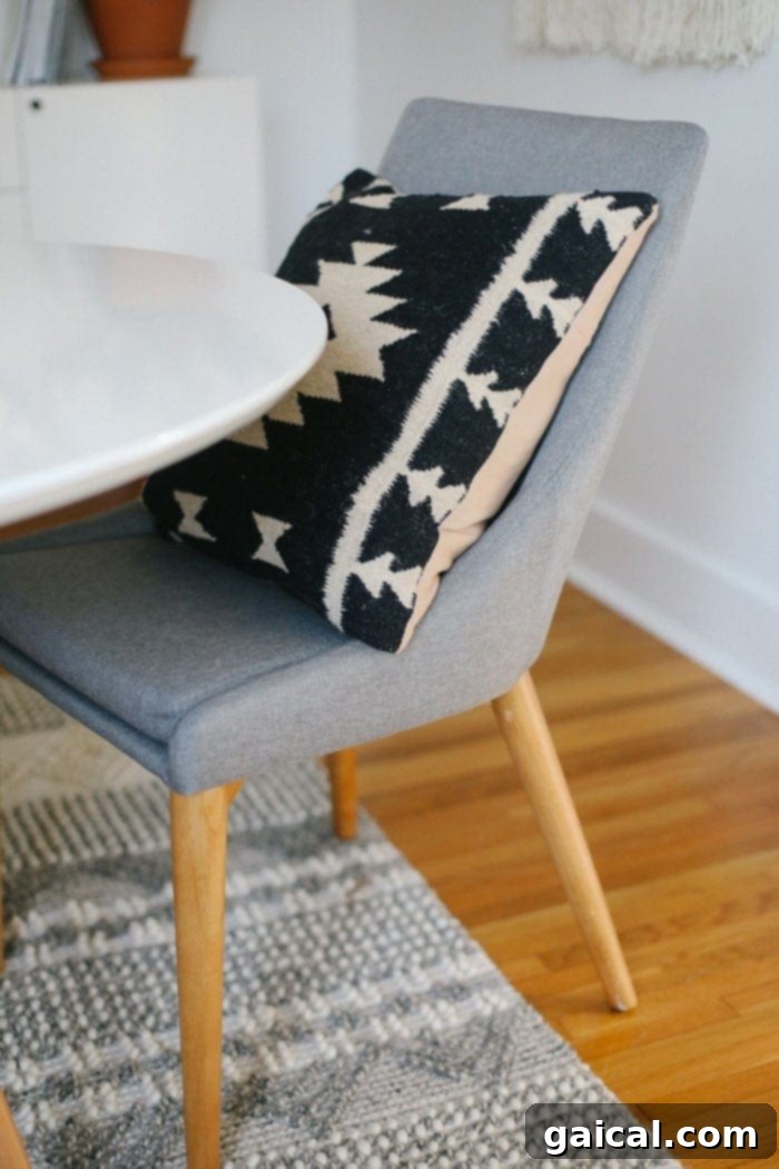 We're talking all things Fit Foodie HQ today with our mid-century home office room reveal! Check out our new multi-person workspace fully equipped with mid-century open shelving for our photography props, plants galore, lots of modern decor, and a wall tapestry! Mid-Century grey chair with aztec pillow