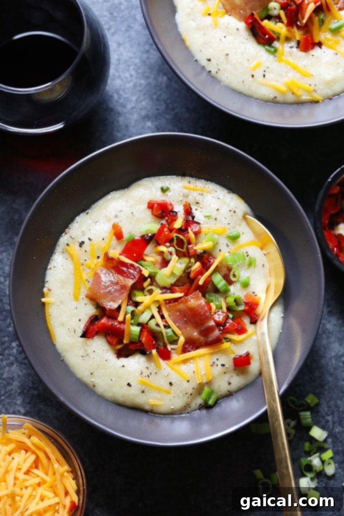 Savor the ultimate creamy comfort: a hearty and healthy loaded cauliflower potato soup, brimming with roasted vegetables and irresistible toppings. A bowl of creamy cauliflower potato soup generously loaded with fresh toppings like crispy bacon, vibrant green onions, and shredded cheese.