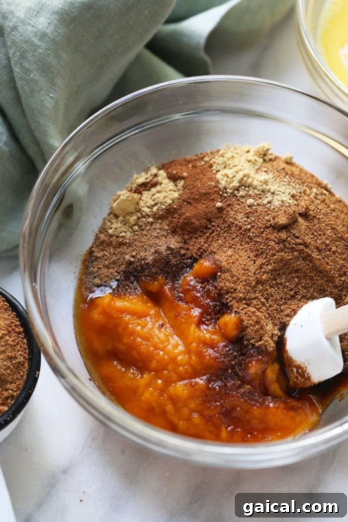 Wholesome Pumpkin Spice Bars 4 A bowl filled with the vibrant orange pumpkin pie bar filling ingredients, showcasing the fresh, wholesome components.