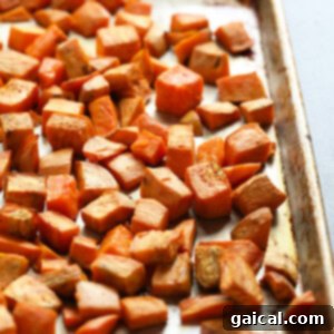Healthy roasted sweet potatoes on a baking sheet.