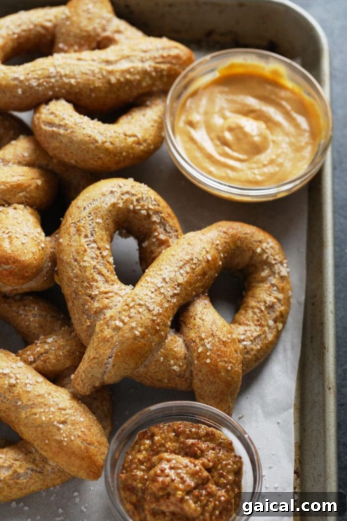 Guilt-Free Homemade Soft Pretzel Recipe 9 Two soft pretzels, one topped with coarse sea salt and another with a sweet cinnamon-sugar coating.