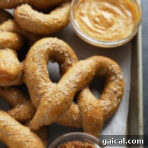 A tray of soft pretzels with peanut butter and mustard.