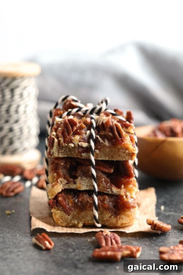 Pecan Pie Bars Ready to Serve Stacked easy pecan pie bars tied with twine, highlighting their rustic charm and delicious layers.