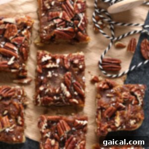Easy pecan bars on a cutting board, perfectly cut into squares.