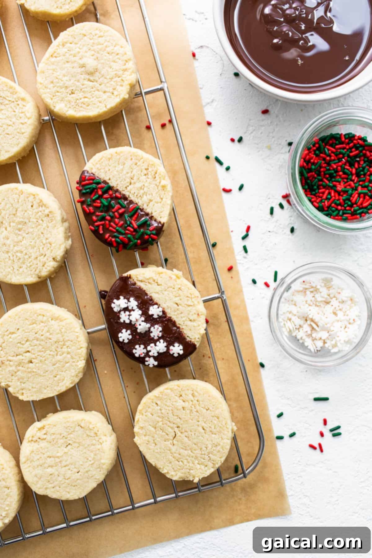 Delicate Almond Flour Shortbread 6 Delicately decorated almond flour shortbread cookies cooling on a wire rack, adorned with melted chocolate and festive sprinkles.
