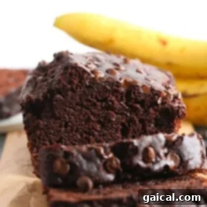 Sliced chocolate banana bread on a cutting board, ready to serve.