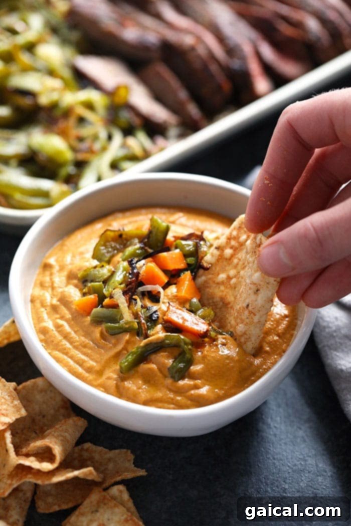 A bowl of addicting vegan queso, made with soaked cashews, nutritional yeast, and secret veggies.