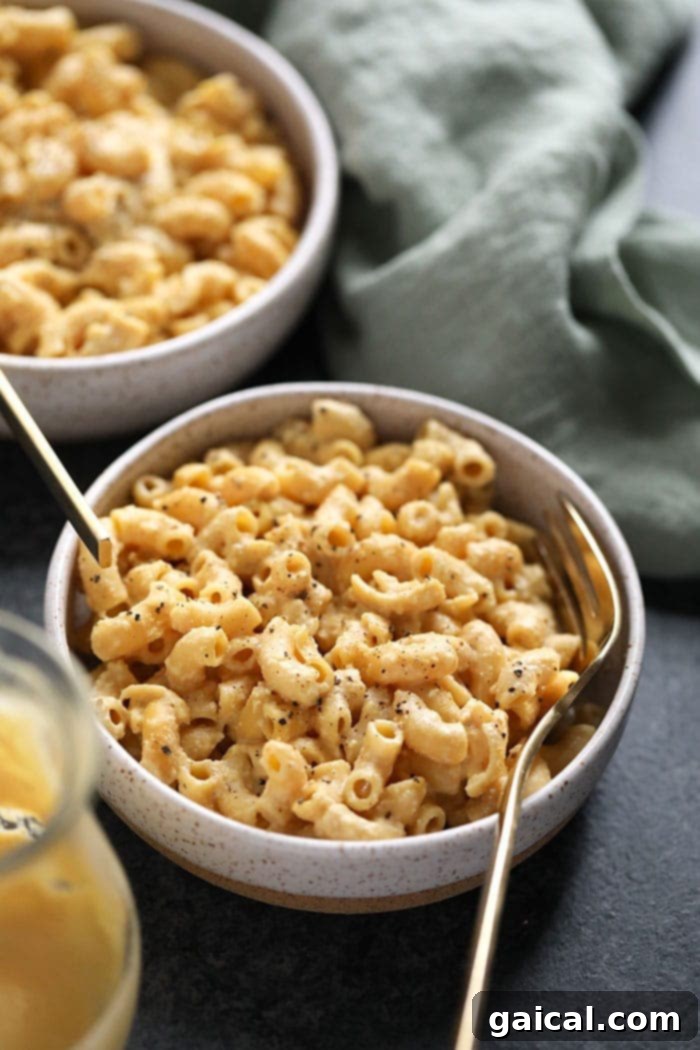 A bowl of creamy vegan mac and cheese, garnished for serving.