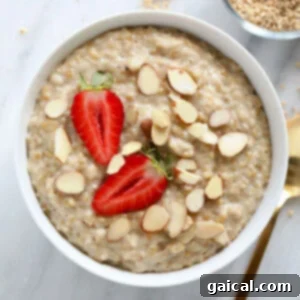 A healthy breakfast idea consisting of oatmeal topped with strawberries and almonds.