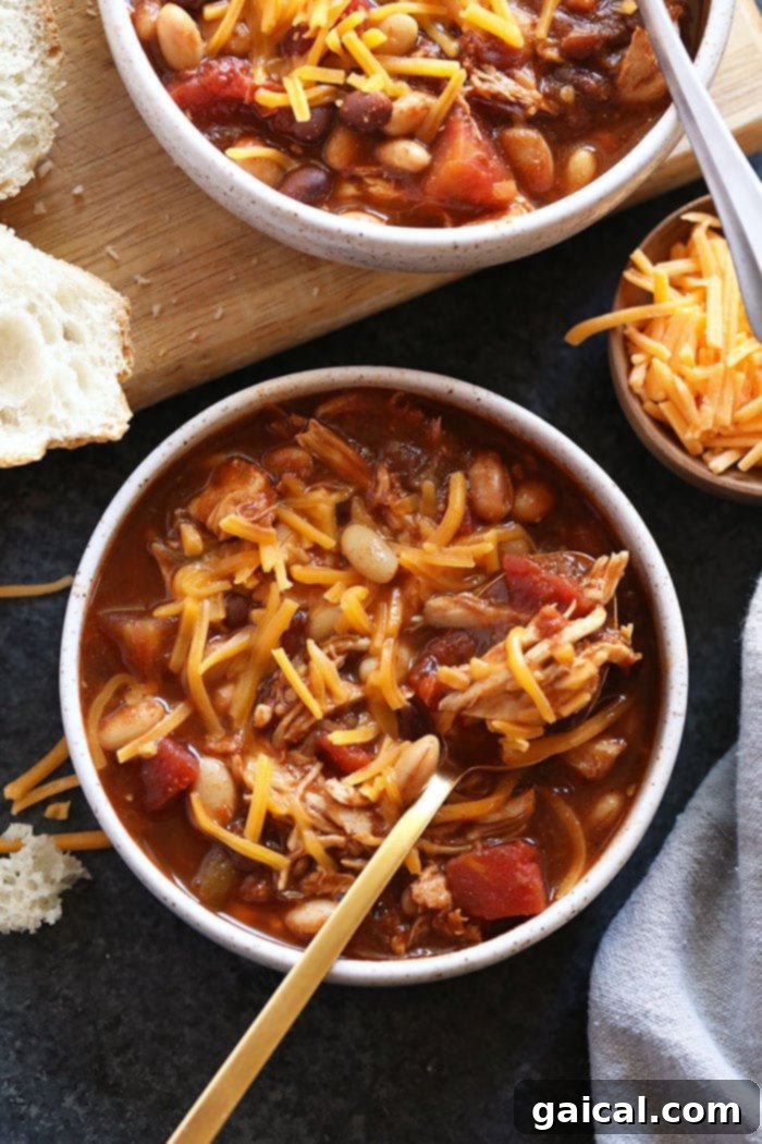 Delicious Chicken Chili: Wholesome and easy meal. A close-up of shredded chicken chili in a bowl, topped with vibrant green cilantro, ready to be enjoyed.