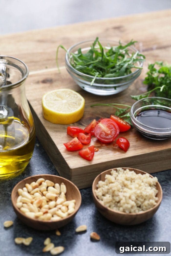 Assortment of fresh ingredients for Mediterranean Vegan Buddha Bowl, including chickpeas, sweet potatoes, and herbs, ready for preparation.