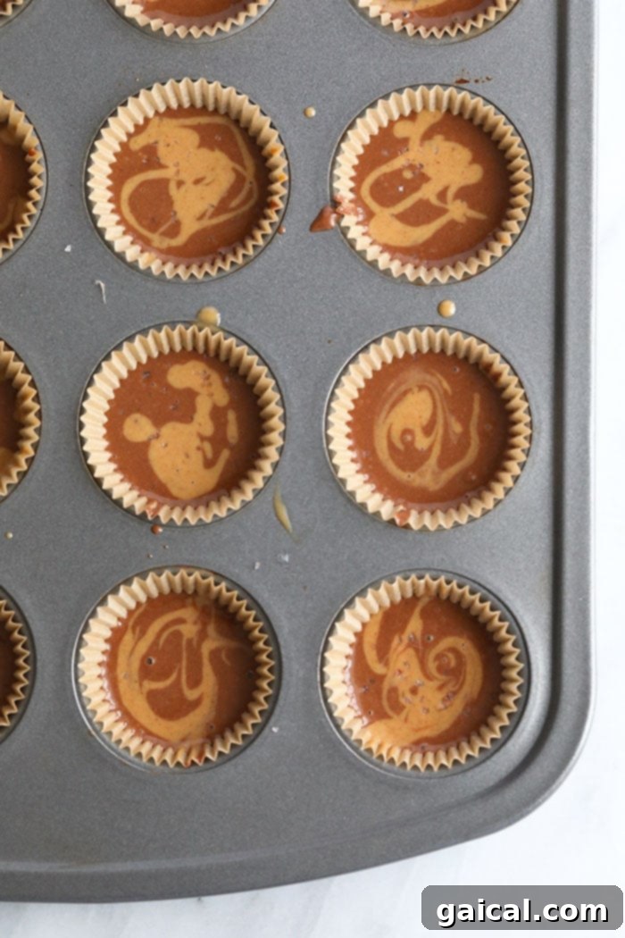 Chocolate Peanut Butter Keto Energy Bites 4 Chocolate Peanut Butter Fat Bomb batter poured into mini muffin tins, ready for freezing