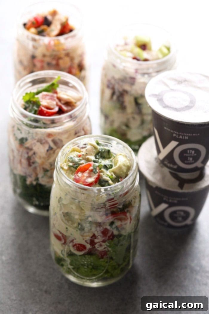 Our healthy chicken salad recipes, featuring a Greek yogurt base and versatile add-ins, are perfectly portioned for individual meal prep in convenient mason jars. Healthy chicken salad in glass mason jars for meal prep
