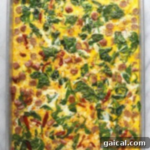 Cooked egg mixture on a baking sheet, ready to be sliced into patties.