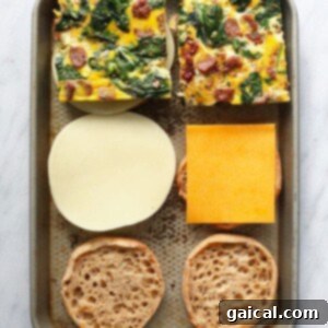 Process of making breakfast sandwiches: egg patty and cheese on English muffin.