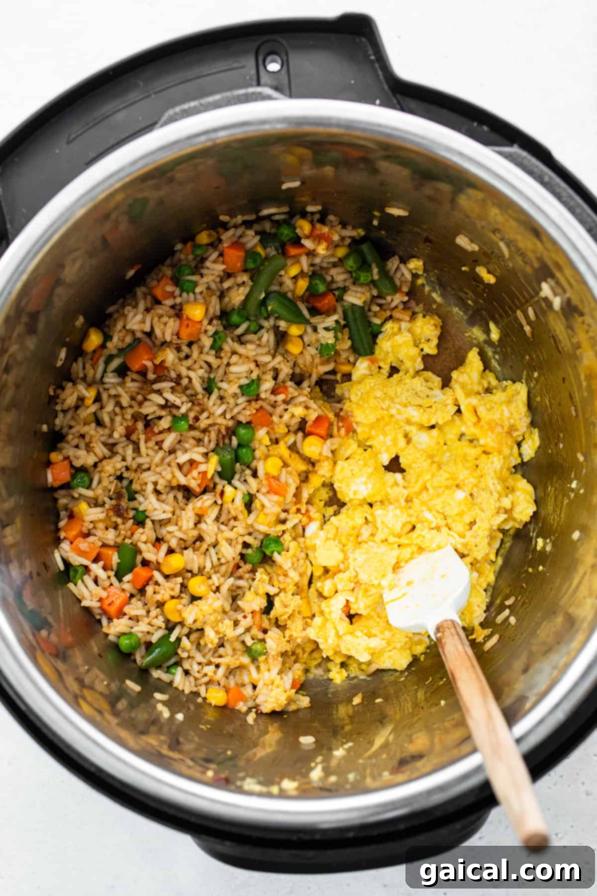 A close-up view of Instant Pot fried rice inside the pressure cooker, highlighting the fluffy white rice, vibrant mixed vegetables, and perfectly scrambled eggs.