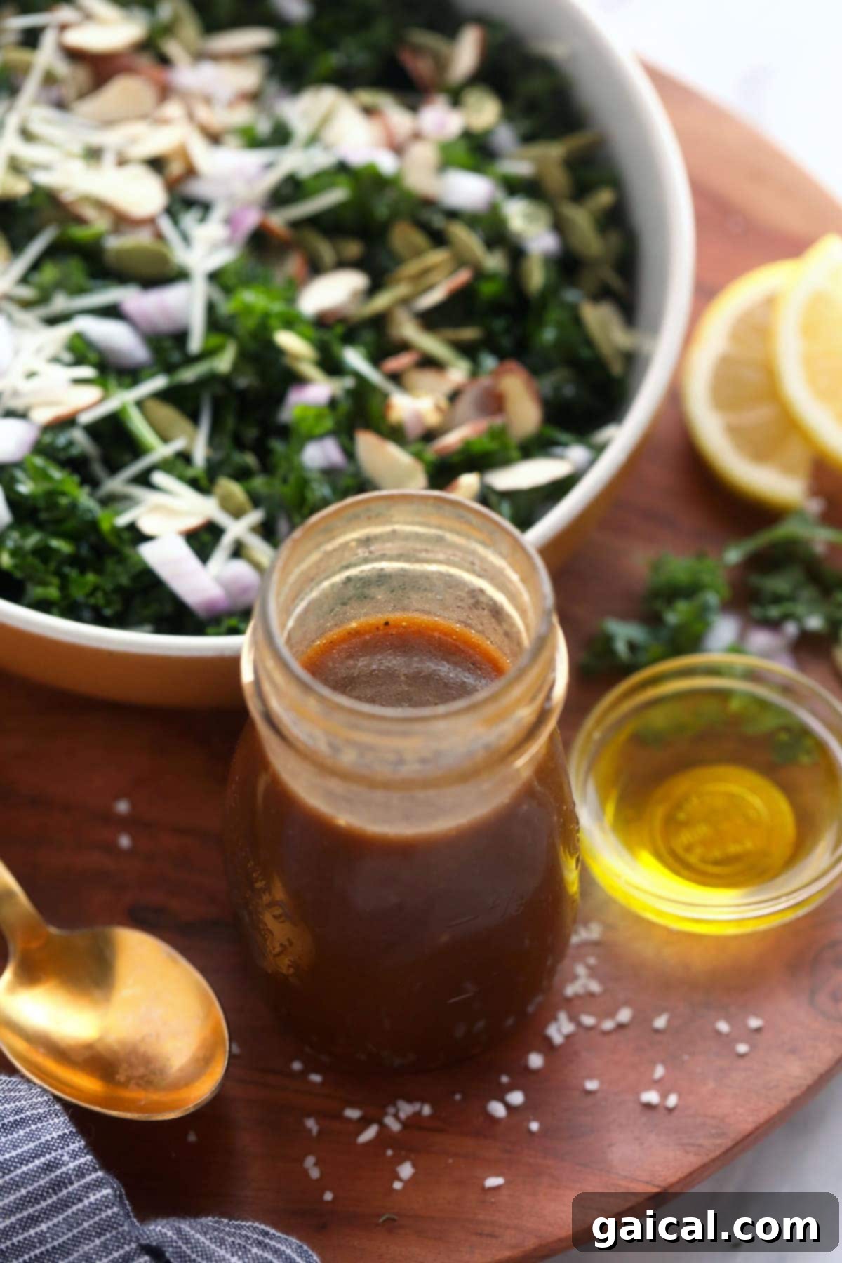Homemade salad dressing is such an easy way to add flavor to not only green salads, but also to grain salads such as quinoa and even meat as a marinade! A vibrant salad with a side of homemade salad dressing in a glass jar, ready to be poured.