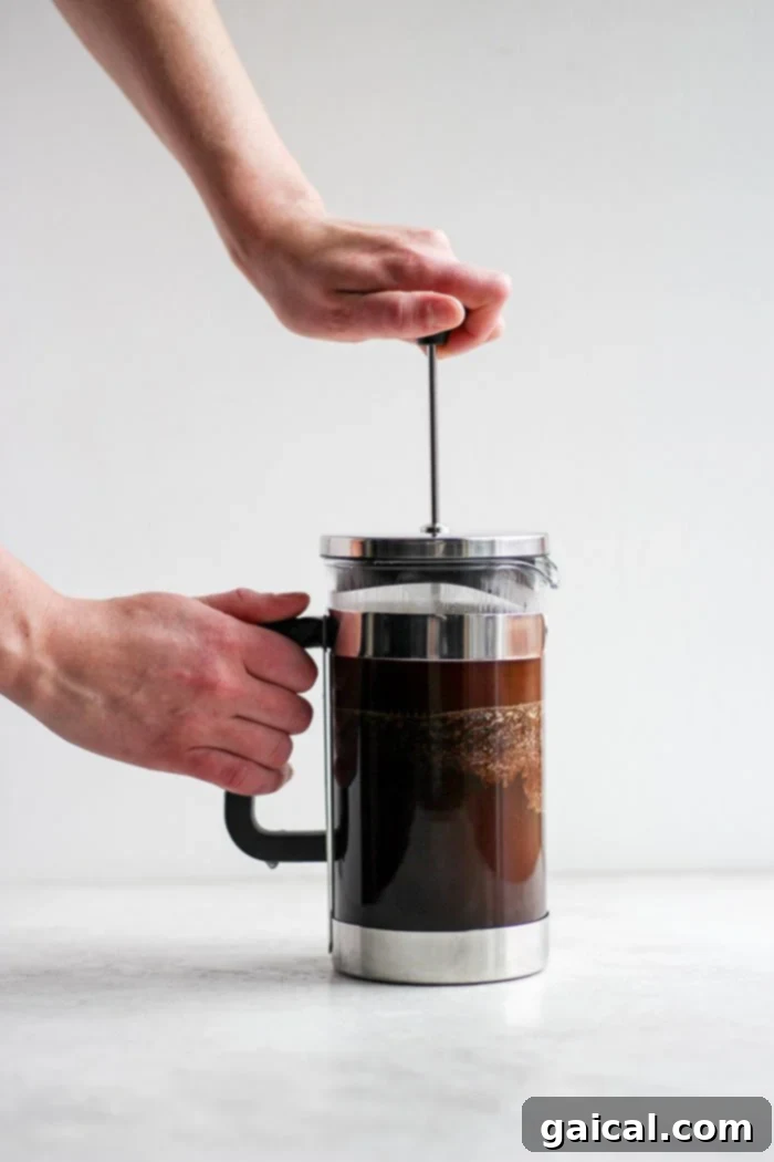 Mastering the French Press 2 A pot of French press coffee brewing, showcasing the rich brown color and froth.