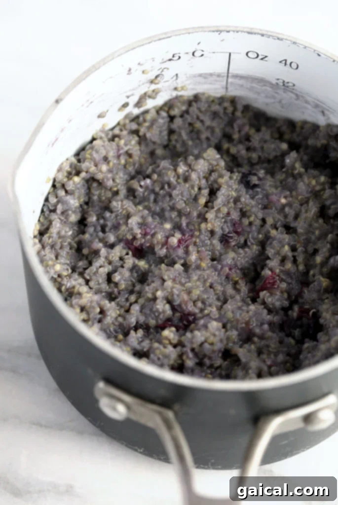 Wholesome Blueberry Quinoa Morning Bowl 3 Blueberry breakfast quinoa being cooked in a pot.
