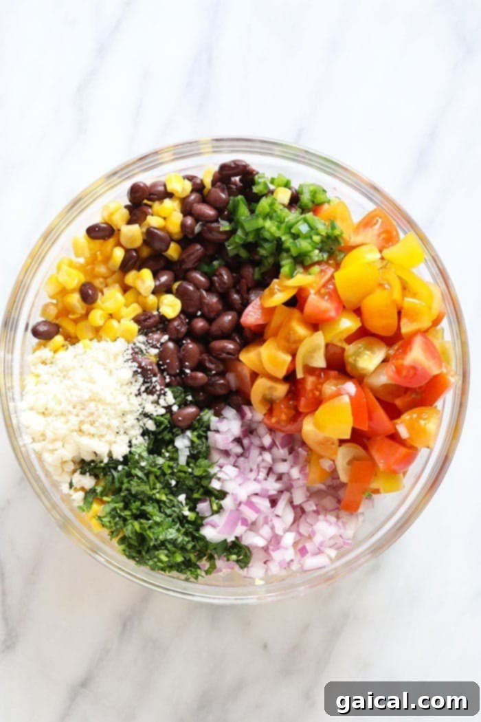 Healthy Black Bean Corn Salad: A Summer Essential Close-up of vibrant black bean corn salad in a white bowl, showing fresh cilantro and diced tomatoes