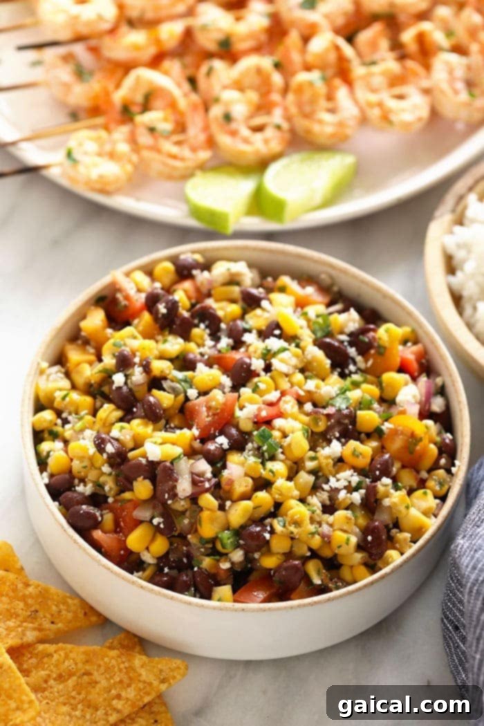 Quick Black Bean Corn Salad: Ready in Minutes A large bowl of fresh black bean and corn salad on a rustic wooden table, ready for serving