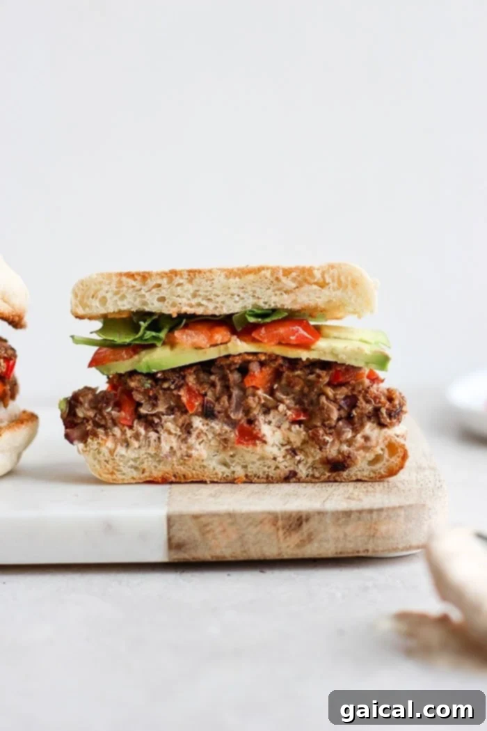 Delicious black bean quinoa burger served on an English muffin, garnished with fresh toppings.