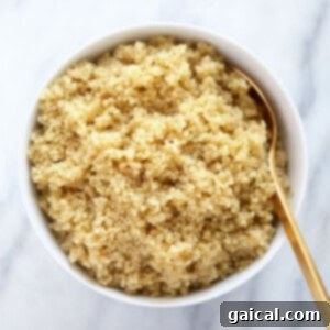 A bowl of fluffy cooked quinoa, ready for incorporation into a recipe.