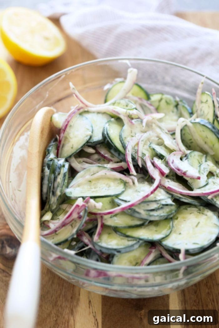 This creamy cucumber salad is a healthy, simple, and delicious side for any BBQ or meal prep. Creamy cucumber salad in a bowl, garnished with fresh dill.