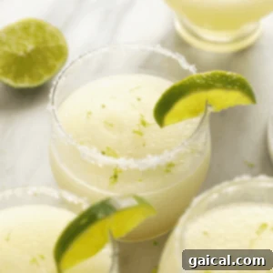 Frozen Margaritas with lime garnish in a stylish glass.