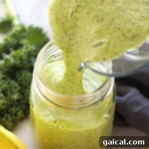 A freshly poured kale smoothie in a glass, ready for serving.