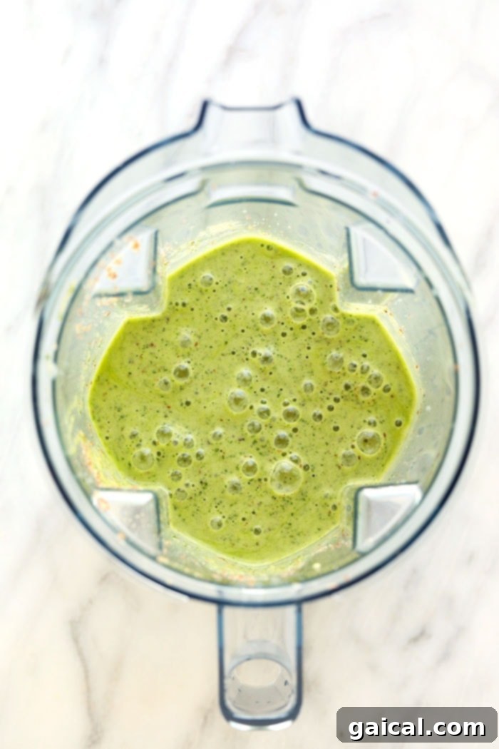 Get your daily greens here! This is the most delicious kale smoothie you'll ever make! It's packed with nutrient dense kale, frozen bananas and the perfect flavor punch of orange juice and fresh ginger. Whip up this green smoothie in 5 minutes and you're off and running with a healthy breakfast or snack on the go. Perfectly blended kale smoothie with a smooth and creamy texture.