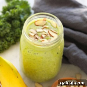 A delicious kale smoothie in a mason jar, ready to be enjoyed.