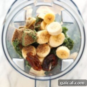 All smoothie ingredients placed in a blender carafe, ready for blending.