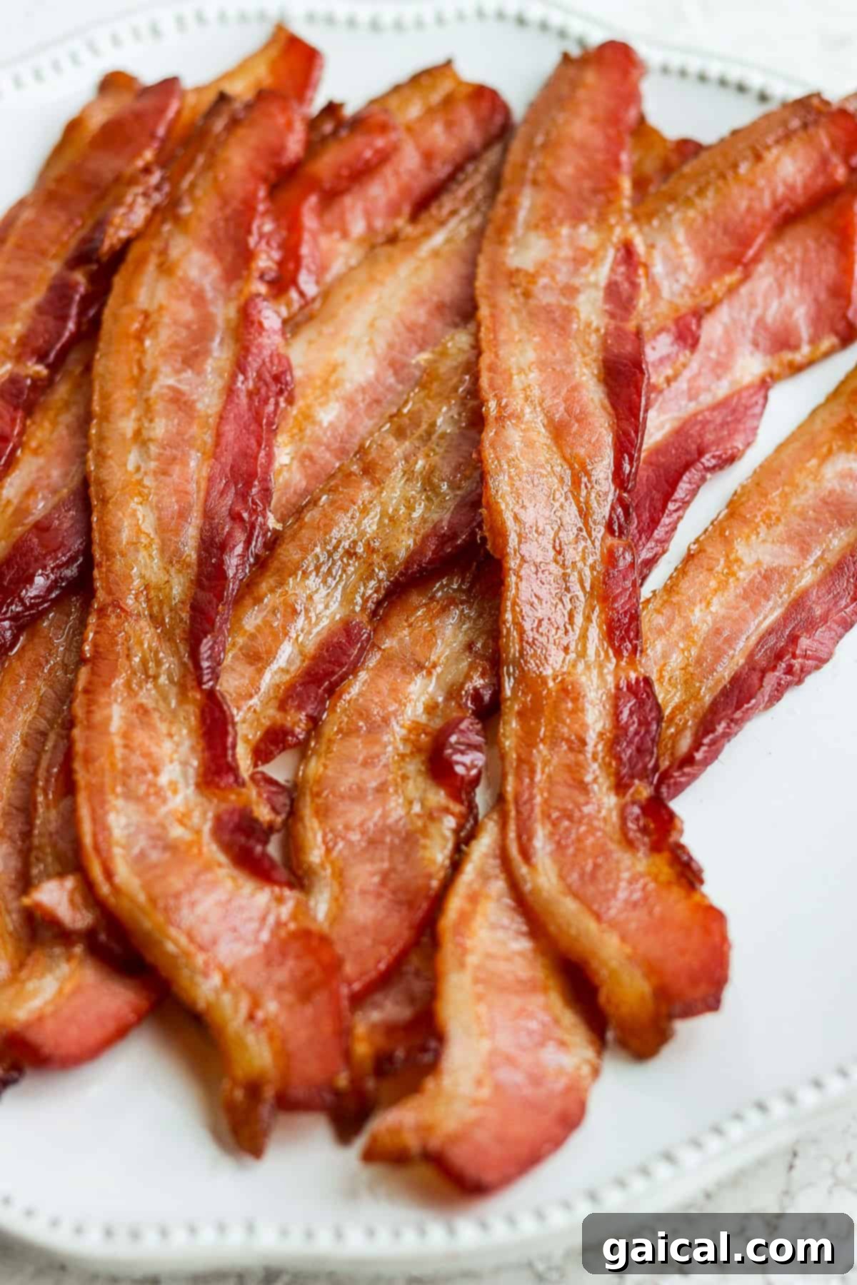 Mastering Crispy Oven Bacon 7 bacon on a white plate.