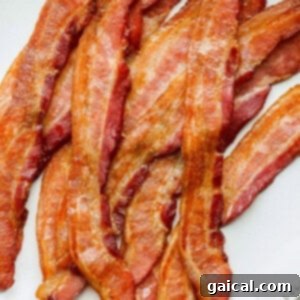 a plate of bacon on a white plate.