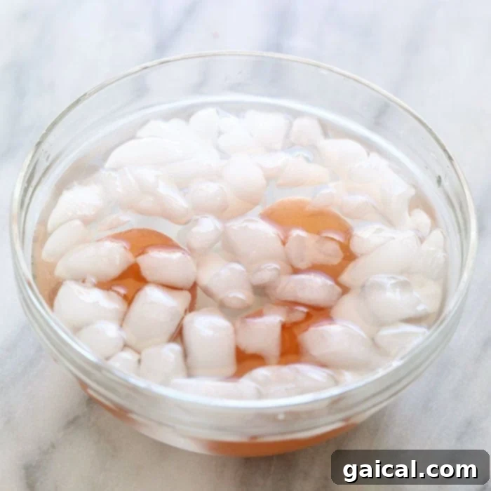 Who is a fan of hard boiled eggs? We are! There are so many ways to prepare hard boiled eggs, but making hard boiled eggs in oven is the easiest way to meal prep hard boiled eggs for breakfast, a healthy egg salad, or for an easy snack throughout the week. Let's chat about how to hard boiled eggs in the oven! Hard-boiled eggs submerged in an ice bath
