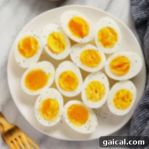 Hearty Tuna Egg Salad 3 Perfectly peeled hard-boiled eggs, ready for any recipe, showing their vibrant yellow yolks and firm white texture.