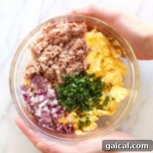 Hearty Tuna Egg Salad 8 Tuna egg salad ingredients in a bowl, showing a medley of flavors and textures ready to be combined.