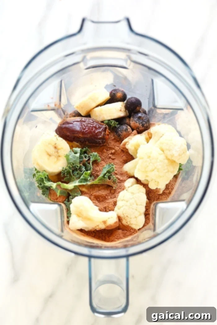 Nutrient-Rich Protein Elixir 3 All the superfood protein smoothie ingredients meticulously placed within a high-speed blender, ready for blending.