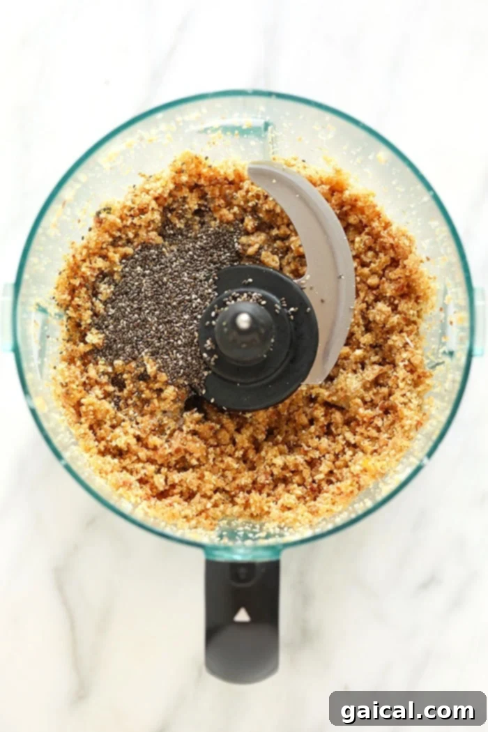 Raw cashews and other energy ball ingredients are ready to be blended in a food processor, creating the foundation for a healthy snack.