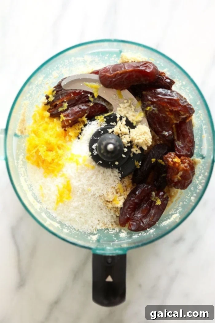 A close-up shot of the mixed energy ball dough in a food processor, featuring a delightful texture with visible chia seeds.