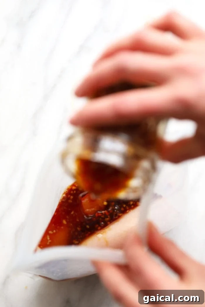 A person pouring freshly made teriyaki sauce into a plastic bag, ready for storage or marination.